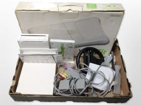 A Nintendo Wii console, Wii Fit board, and other accessories.