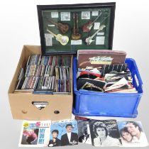 A quantity of vinyl LPs, 45 singles and CDs, together with a framed musical montage.