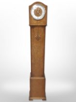 An oak granddaughter clock with silvered dial, height 127cm, with pendulum.