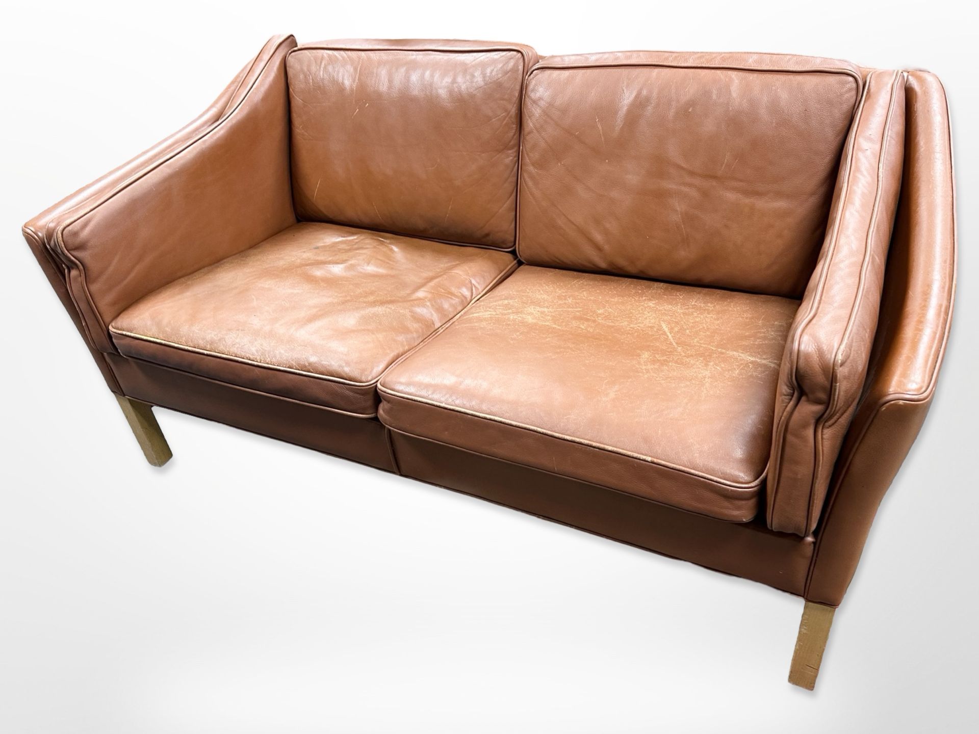 A late 20th-century Danish terracotta leather two-seater settee, length 154cm x depth 80cm x 71cm.