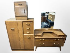 A mid-20th century oak three-piece bedroom suite comprising of a sunk-centre mirror-backed dressing