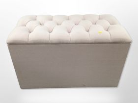 A contemporary storage ottoman in buttoned upholstery, width 91cm.