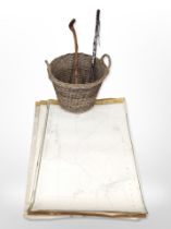 A twin-handled wicker hamper containing rolled maps