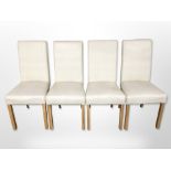 A set of four contemporary cream stitched leather dining chairs.