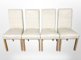 A set of four contemporary cream stitched leather dining chairs.