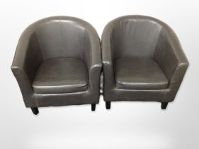 A pair of contemporary brown leather armchairs.