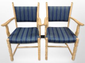 A pair of Danish blonde oak-framed armchairs in striped upholstery, width 61cm.