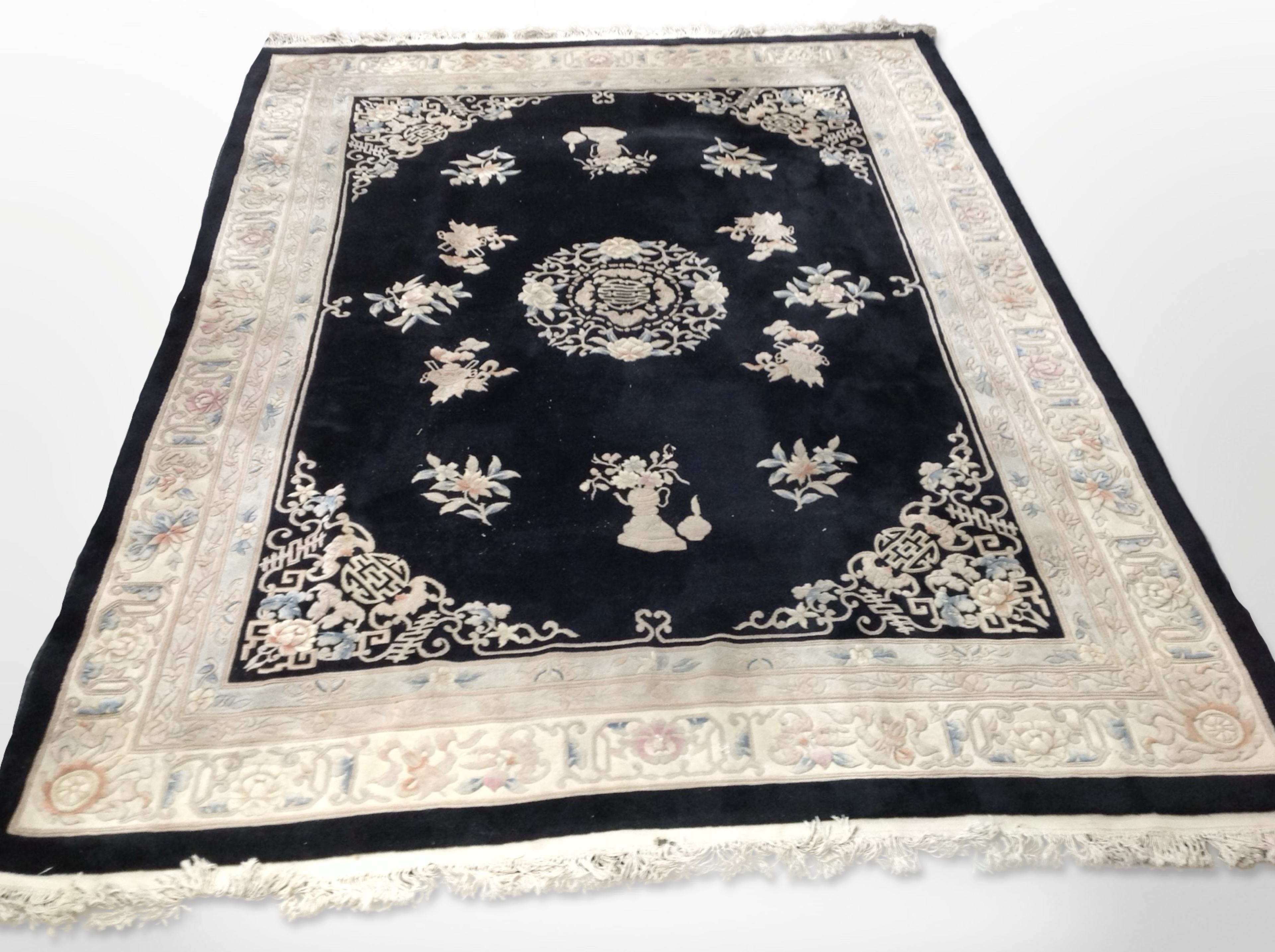 A Chinese carpet on black ground, 390cm x 275cm.