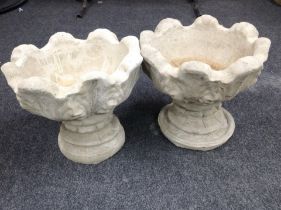 A pair of concrete garden urns,