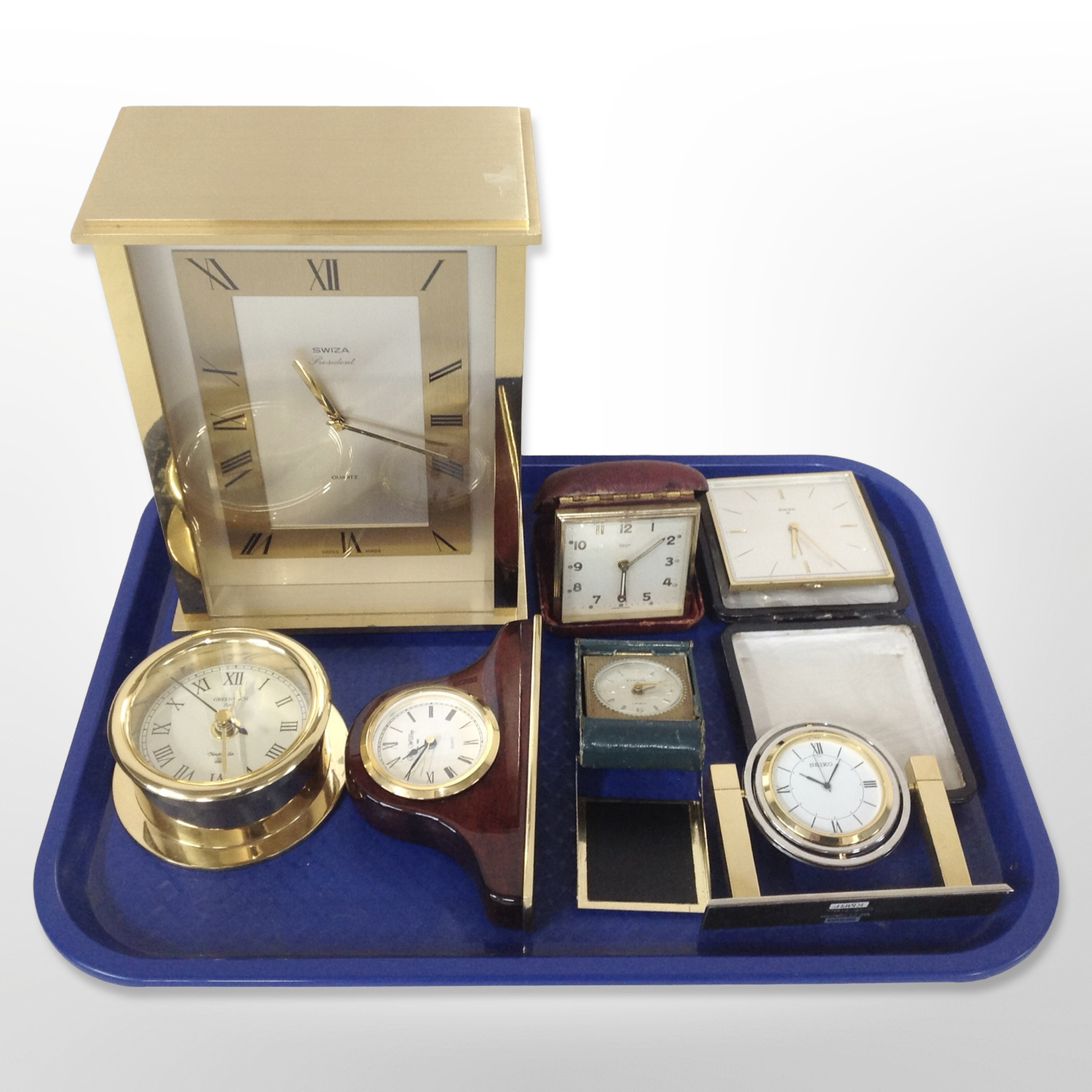 A group of timepieces including Swiza President, quartz mantel timepiece, others including Seiko,