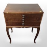 A mid-20th century walnut three-drawer cutlery chest on cabriole legs,