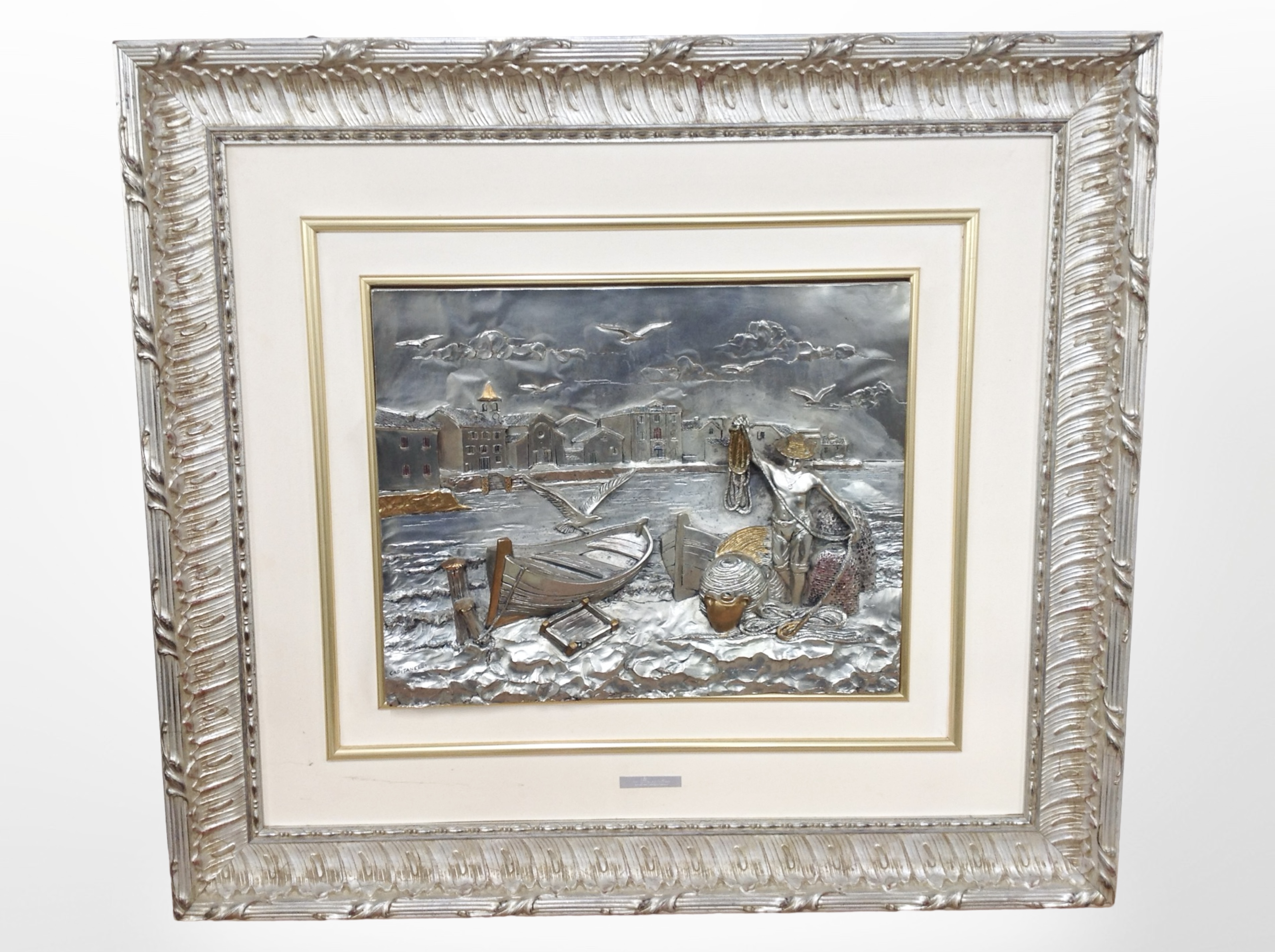 An Italian embossed silver relief picture depicting a fisherman, signed Capitanelli,