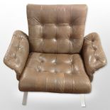 A 20th-century Danish chrome-framed armchair upholstered in brown stitched and buttoned leather,