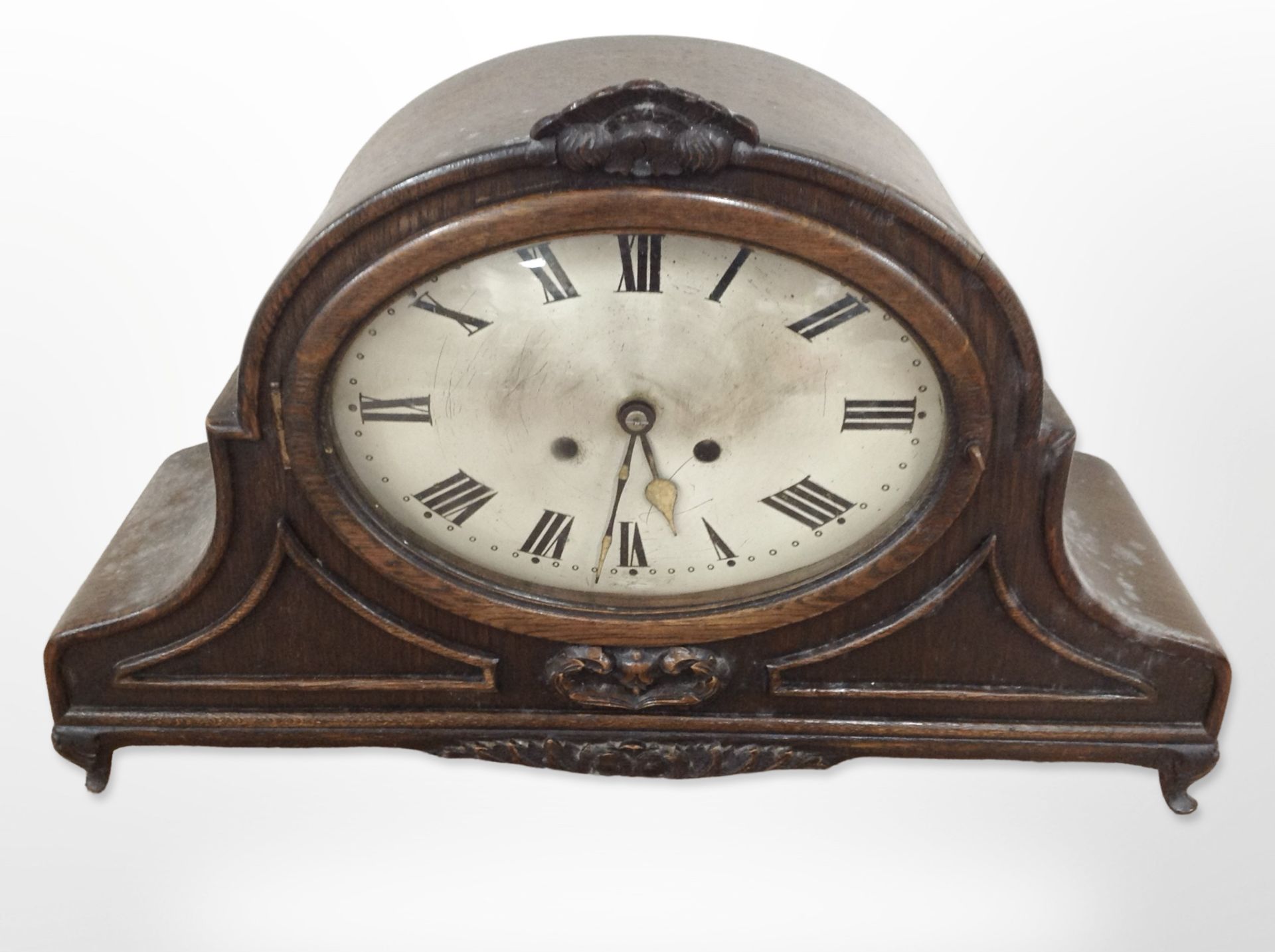 A late Victorian oak mantel clock with silvered dial, height 33cm,