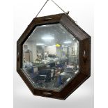 An Edwardian carved oak octagonal mirror, width 58cm.