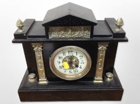 A Victorian slate and brass mantel clock with enamelled dial,