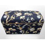 An upholstered ottoman in floral fabric, width 88cm.
