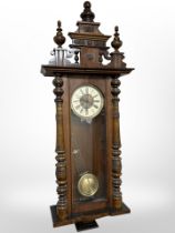 An Edwardian Vienna style wall clock with key and pendulum, height approximately 135 cm.