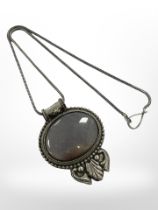 A cabochon necklace mounted in white metal