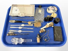 A group of collectables including wine stoppers, 1940's pefume bottle, shellfish picks,