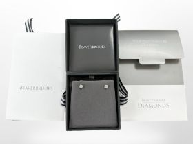 A pair of 9ct white gold diamond earrings, retailed by Beaverbrooks, with original retail box,