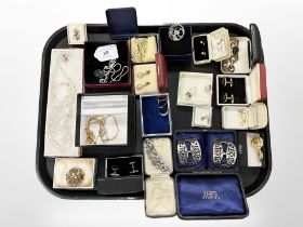 A group of costume jewellery, belt buckles in case,