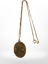 An antique yellow rolled gold locket suspended on 9ct yellow gold chain