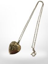 A 9ct yellow gold plated heart locket suspended on 9ct yellow gold chain