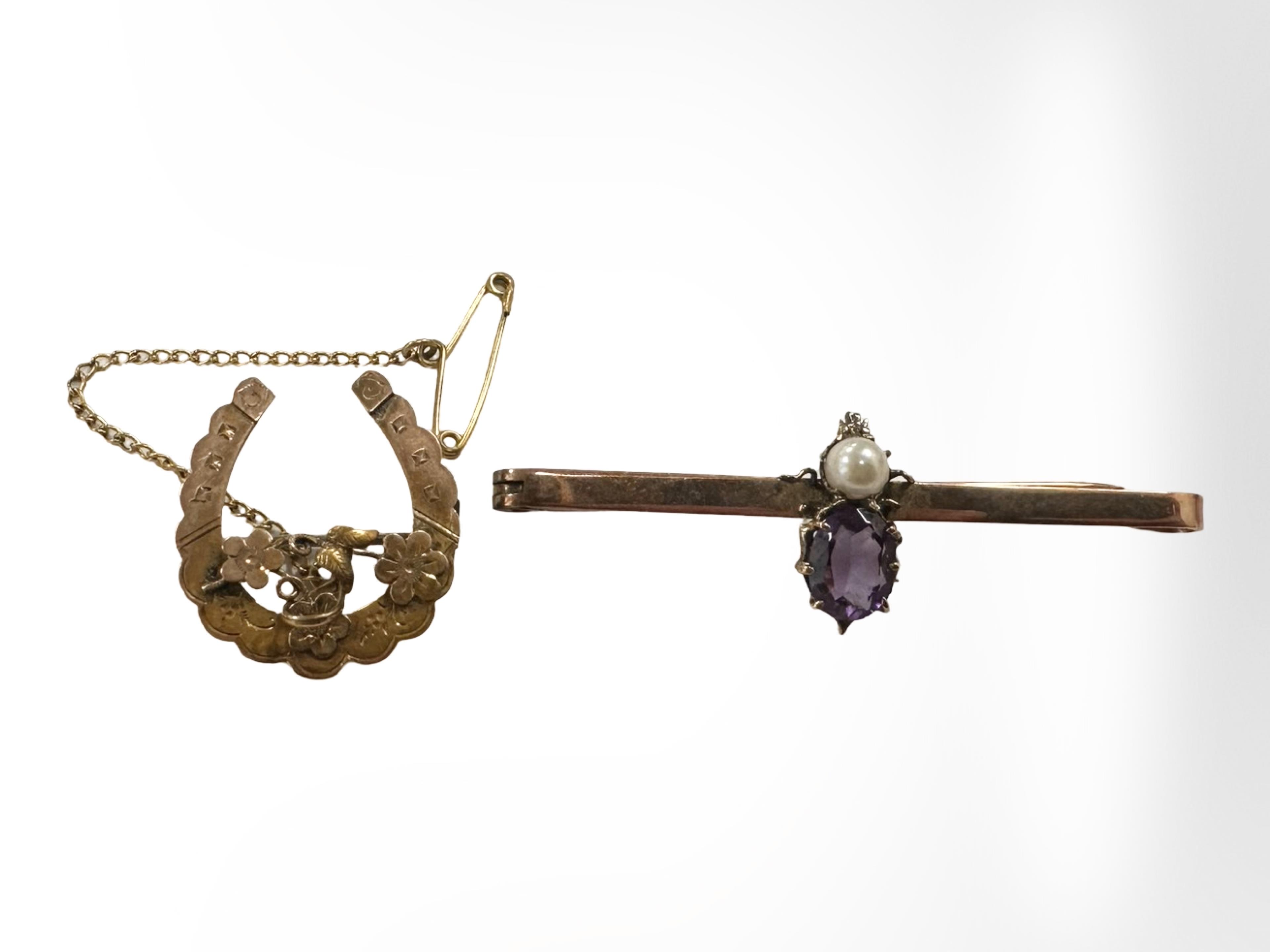 A 9ct gold horseshoe brooch and an amethyst and pearl brooch. CONDITION REPORT: 4.