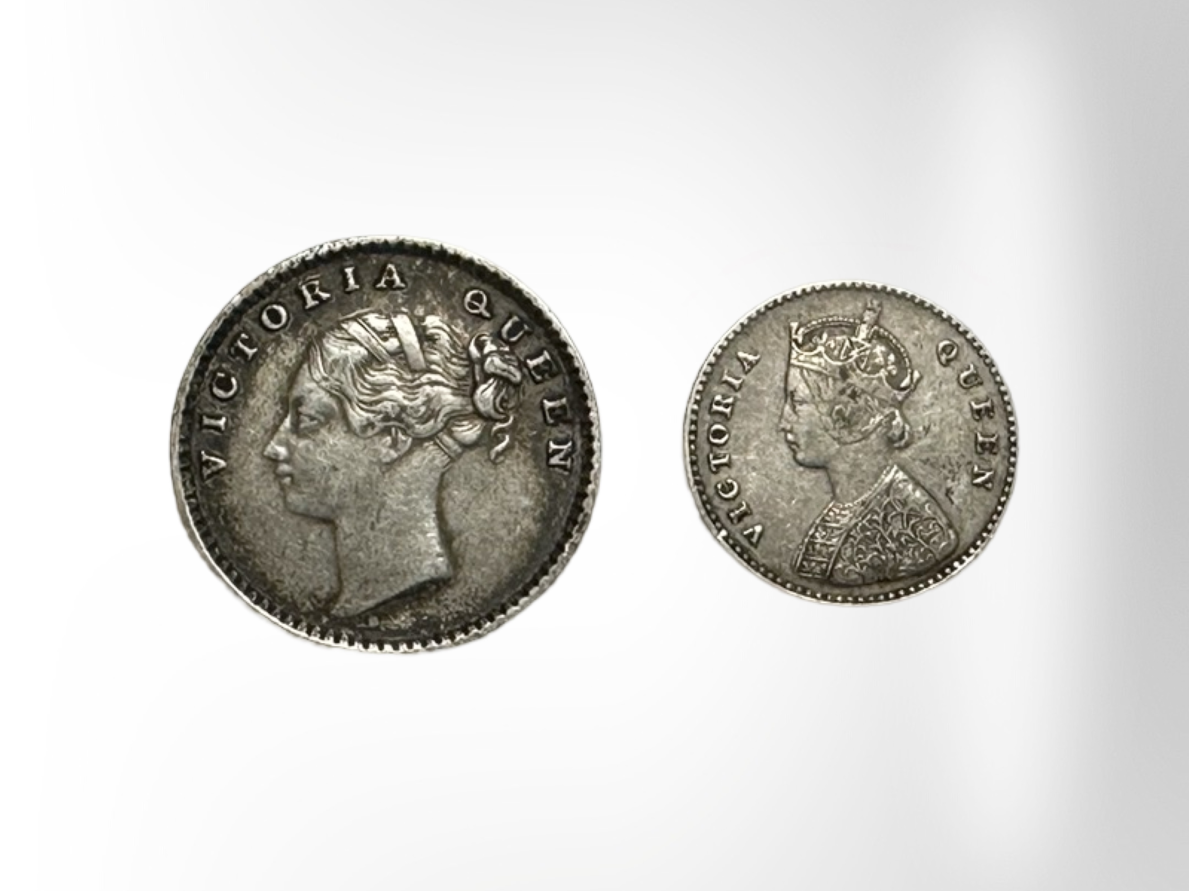 A quarter silver rupee 1840 and an 1862 2 Annas coin.