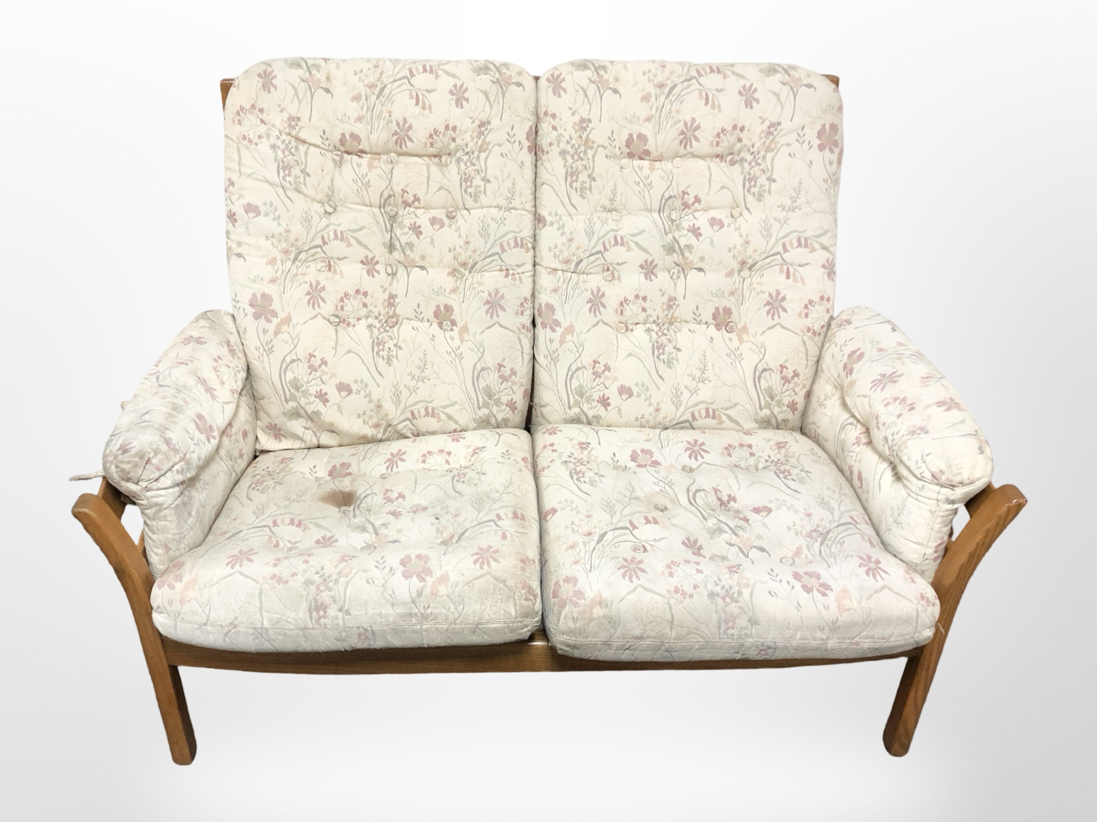 An Ercol stained elm three piece lounge suite in floral upholstery,