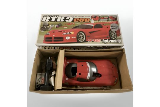 An RTR3 Evo 1:10 scale four wheel drive remote control car, in box.