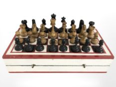 A painted wooden chess box and a set of turned box wood pieces, kings 9 cm high.