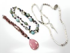 A pink rough cut gemstone necklace with polished lozenge pendant together with two further