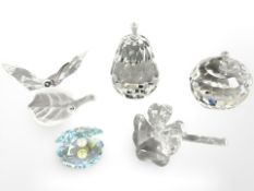A group of decorative crystal ornaments including apple and pear, butterfly on leaf,