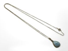 A 14ct yellow gold fine chain with blue lozenge shaped pendant probably Larimar mounted in 14ct