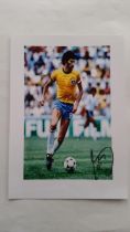 FOOTBALL, Socrates signed photograph, colour photograph showing him in Brazil match, signed in black