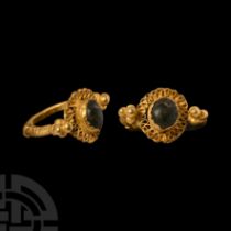Late Roman or Merovingian Gold Ring with Rosette and Green Cabochon