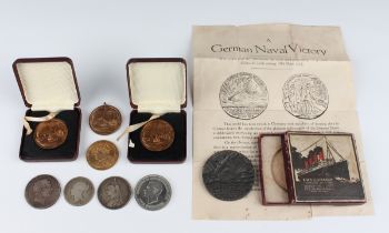 A small collection of coins and medallions, including a George III crown 1818, a Victoria Jubilee