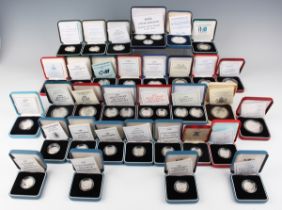 A large collection of Elizabeth II Royal Mint silver proof commemorative coins, including a United
