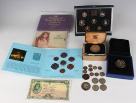 An Elizabeth II sovereign 1979, cased and boxed, together with a group of commemorative coins,