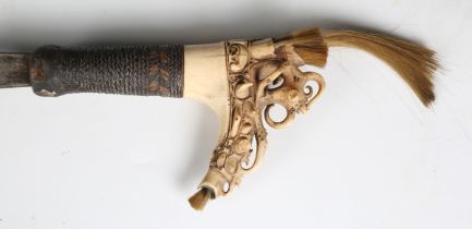 An early 20th century Dayak mandau with curved hatchet-section blade, blade length 44.5cm, woven