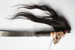 An early 20th century Dayak Mandau with curved hatchet-section blade, blade length 56cm, with some