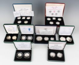 A group of eight Elizabeth II Royal Mint silver proof coin sets, including a United Kingdom