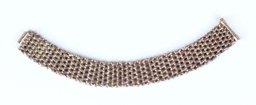 A gold bracelet in a wide woven oval link design, on a sliding clasp, unmarked, weight 26.1g, length