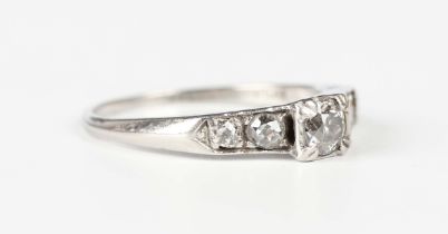 A platinum, iridium and diamond ring, mounted with the principal cushion cut diamond between diamond