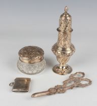 A small group of silver, comprising an embossed sugar caster of ogee baluster form, London 1902 by