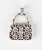 A white gold and diamond pendant, designed as a handbag with pierced decoration, mounted with