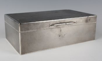 A George V silver rectangular cigar box with engine turned decoration, the hinged lid interior