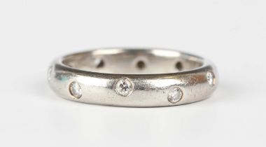 A Tiffany & Co platinum and diamond band ring, mounted with circular cut diamonds, detailed 'T & Co.